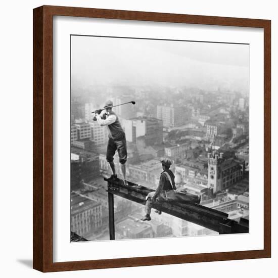 Golfer Teeing off on Girder High above City-null-Framed Photographic Print