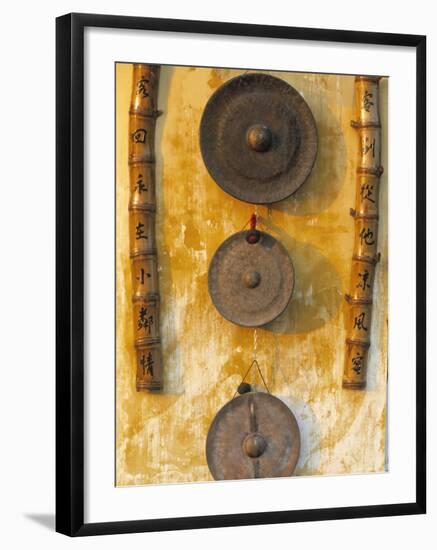 Gongs Hanging on a Wall, Vietnam-Peter Adams-Framed Photographic Print