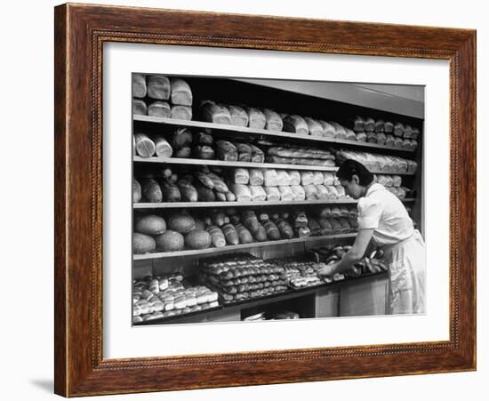 Good of Worker in Bakery Standing in Front of Shelves of Various Kinds of Breads and Rolls-Alfred Eisenstaedt-Framed Photographic Print