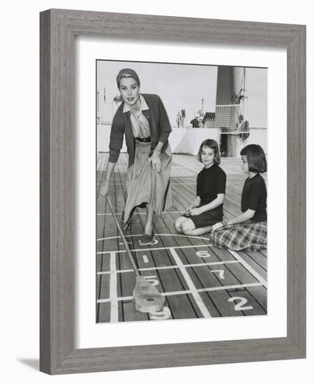 Grace Kelly by Playing Shuffleboard on the Deck of the Uss Constitution, April 10, 1956-null-Framed Premium Photographic Print