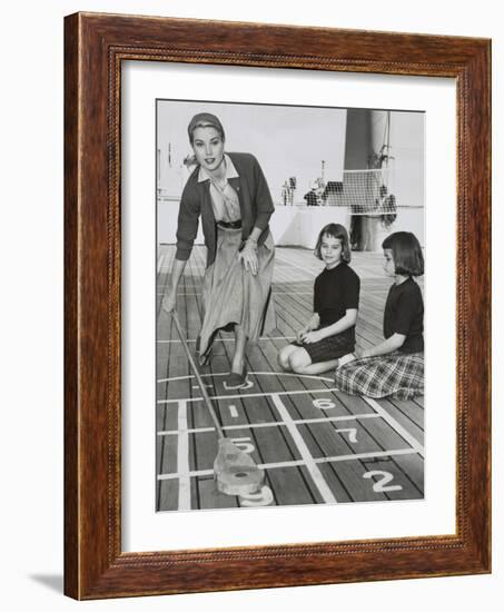 Grace Kelly by Playing Shuffleboard on the Deck of the Uss Constitution, April 10, 1956-null-Framed Premium Photographic Print