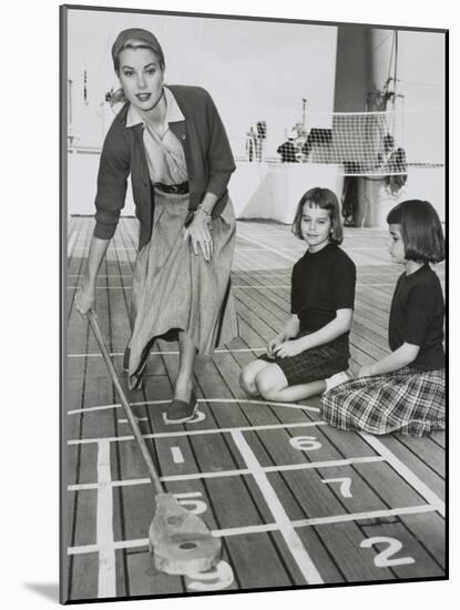 Grace Kelly by Playing Shuffleboard on the Deck of the Uss Constitution, April 10, 1956-null-Mounted Photo