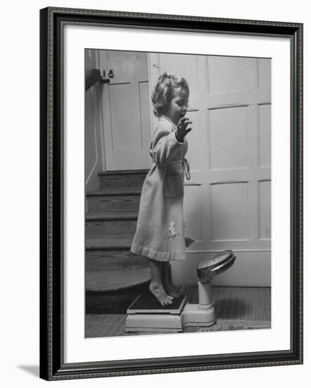 Grand Daughter of Winston Churchill, Arabella Spencer Churchill, Jouncing on Bathroom Scale-Carl Mydans-Framed Premium Photographic Print
