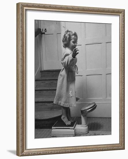 Grand Daughter of Winston Churchill, Arabella Spencer Churchill, Jouncing on Bathroom Scale-Carl Mydans-Framed Premium Photographic Print