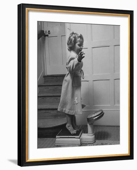 Grand Daughter of Winston Churchill, Arabella Spencer Churchill, Jouncing on Bathroom Scale-Carl Mydans-Framed Premium Photographic Print