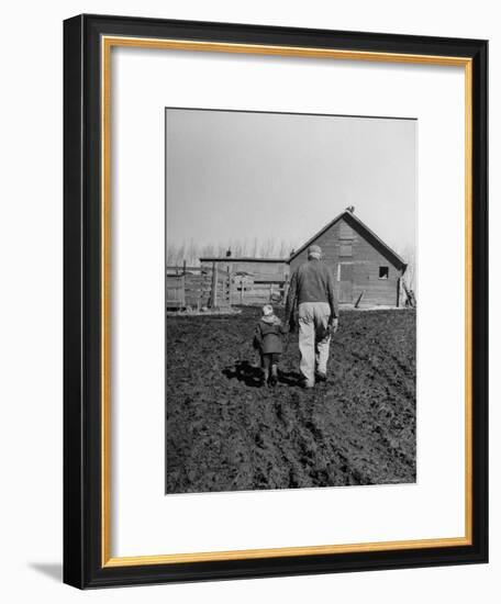 Grandpa and 4 Year Old Granddaughter, on Morning Chores, to Feed Pigs on Nearby Lot-Gordon Parks-Framed Premium Photographic Print