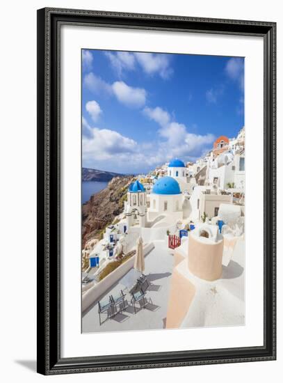 Greek Church with Three Blue Domes in the Village of Oia-Neale Clark-Framed Photographic Print