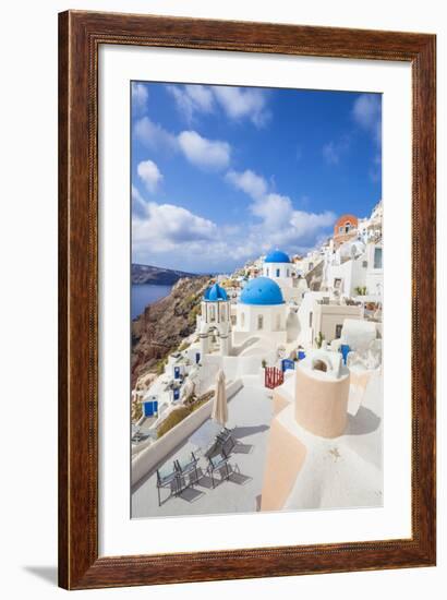 Greek Church with Three Blue Domes in the Village of Oia-Neale Clark-Framed Photographic Print