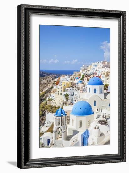 Greek Church with Three Blue Domes in the Village of Oia-Neale Clark-Framed Photographic Print