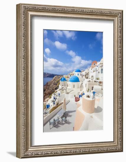 Greek Church with Three Blue Domes in the Village of Oia-Neale Clark-Framed Photographic Print