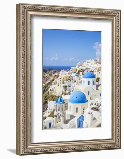 Greek Church with Three Blue Domes in the Village of Oia-Neale Clark-Framed Photographic Print