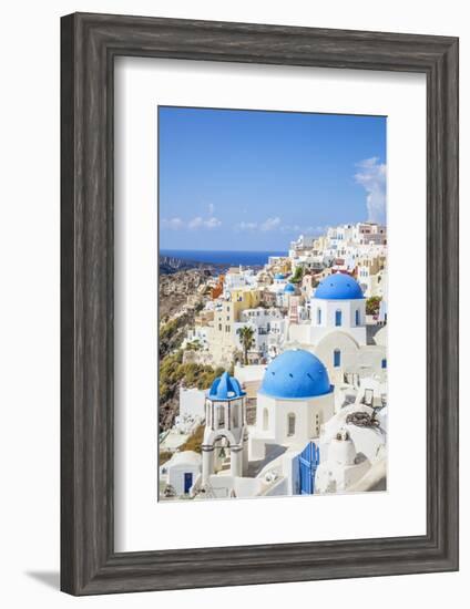 Greek Church with Three Blue Domes in the Village of Oia-Neale Clark-Framed Photographic Print