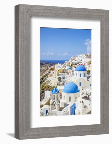 Greek Church with Three Blue Domes in the Village of Oia-Neale Clark-Framed Photographic Print