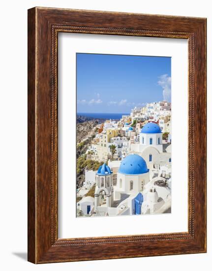 Greek Church with Three Blue Domes in the Village of Oia-Neale Clark-Framed Photographic Print