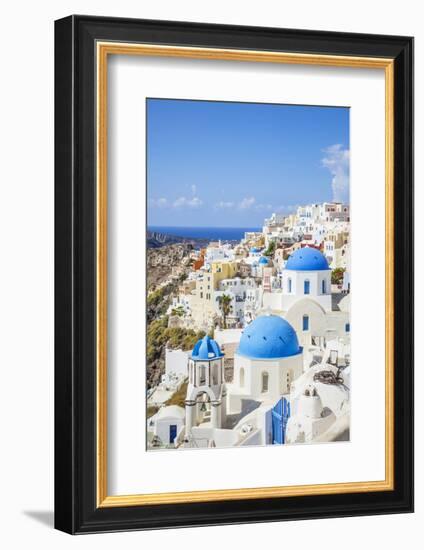 Greek Church with Three Blue Domes in the Village of Oia-Neale Clark-Framed Photographic Print