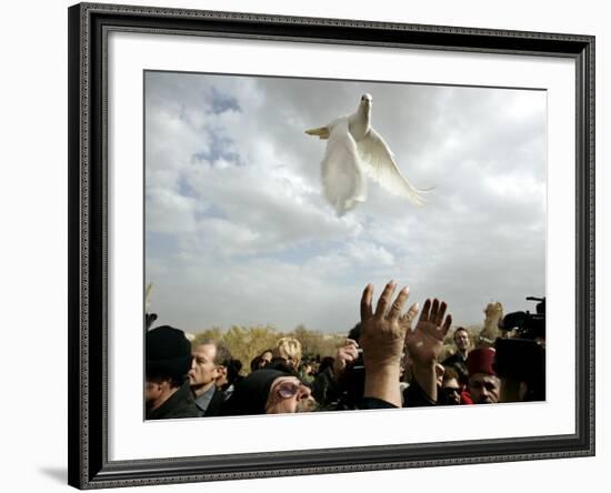 Greek Orthodox Priest Releases a Dove During a Traditional Ceremony at Jordan River Baptismal Site-null-Framed Photographic Print