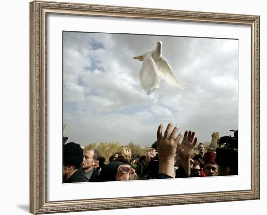 Greek Orthodox Priest Releases a Dove During a Traditional Ceremony at Jordan River Baptismal Site-null-Framed Photographic Print