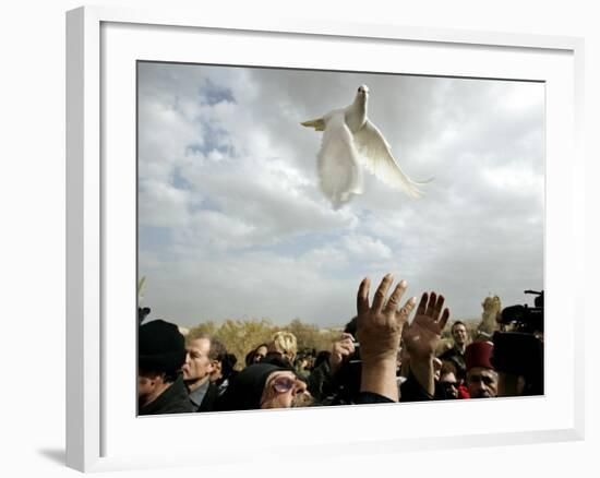 Greek Orthodox Priest Releases a Dove During a Traditional Ceremony at Jordan River Baptismal Site--Framed Photographic Print