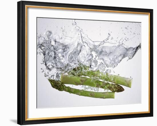 Green Asparagus Falling into Water-Kröger & Gross-Framed Photographic Print