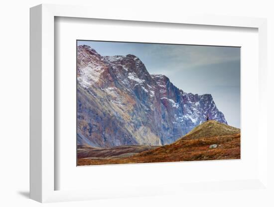 Greenland. Kong Oscar Fjord. Ella Island. Hiker dwarfed by rocky mountains.-Inger Hogstrom-Framed Photographic Print