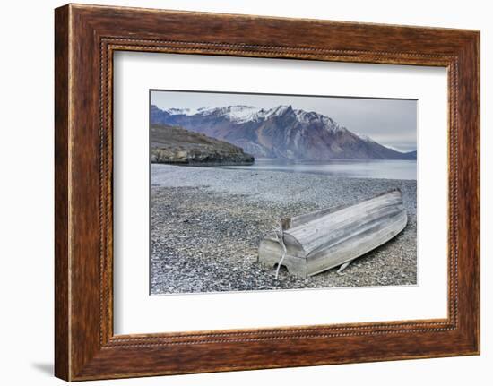 Greenland, Kong Oscar Fjord. Ella Island. Weathered boat on the shore.-Inger Hogstrom-Framed Photographic Print