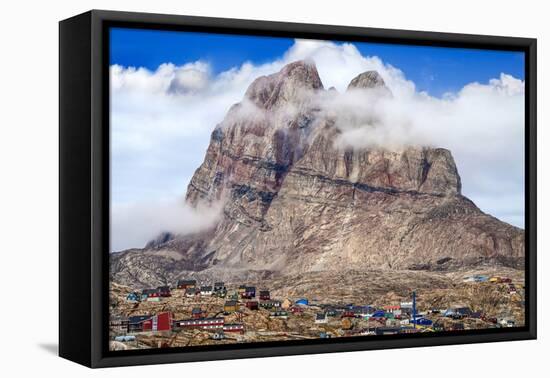 Greenland, Uummannaq. Uummannaq mountain (1170 m, 3839 ft) looms over the fishing village of Uumman-Miva Stock-Framed Premier Image Canvas