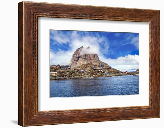 Greenland, Uummannaq. Uummannaq mountain (1170 m, 3839 ft) looms over the fishing village of Uumman-Miva Stock-Framed Photographic Print