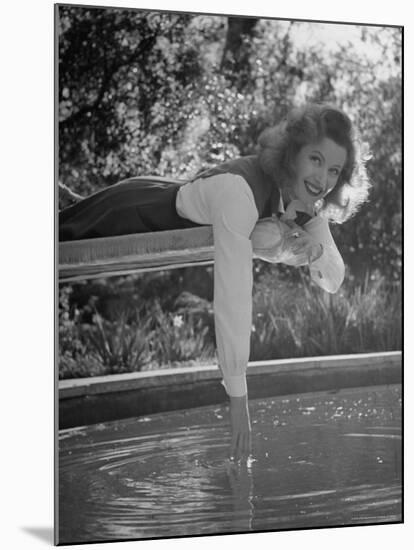 Greer Garson Dangling Her Hand in Pool as She Lounges on Diving Board-Peter Stackpole-Mounted Premium Photographic Print