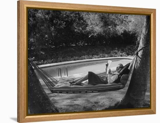 Greer Garson Reading While Relaxing in a Hammock Near Her Pool at Home-Peter Stackpole-Framed Premier Image Canvas