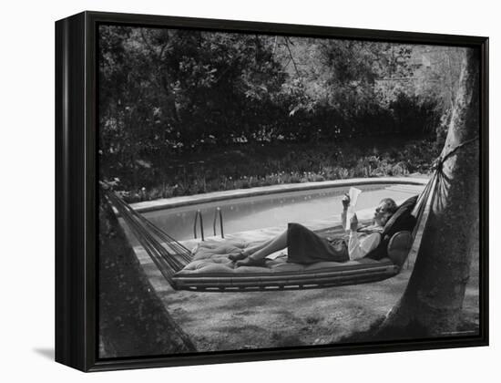 Greer Garson Reading While Relaxing in a Hammock Near Her Pool at Home-Peter Stackpole-Framed Premier Image Canvas