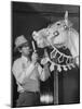 Groom Cleaning Horse's Teeth During Filming of the Movie "The Ziegfeld Follies"-John Florea-Mounted Photographic Print