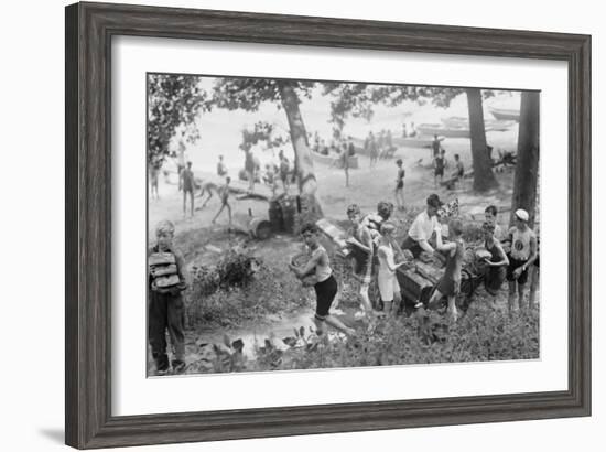 Group of Boys Carry Loaves of Bread from Wagons Near Beach Front in Woods.-null-Framed Art Print