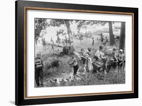 Group of Boys Carry Loaves of Bread from Wagons Near Beach Front in Woods.-null-Framed Art Print