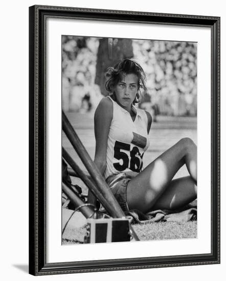 Gunhild Larking, Sweden's Entry for High Jump, Nervously Awaiting Turn to Compete at Olympic Games-George Silk-Framed Premium Photographic Print