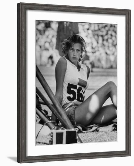 Gunhild Larking, Sweden's Entry for High Jump, Nervously Awaiting Turn to Compete at Olympic Games-George Silk-Framed Premium Photographic Print