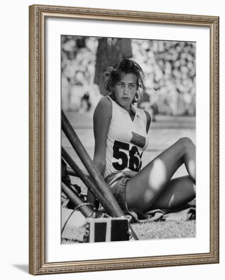 Gunhild Larking, Sweden's Entry for High Jump, Nervously Awaiting Turn to Compete at Olympic Games-George Silk-Framed Premium Photographic Print