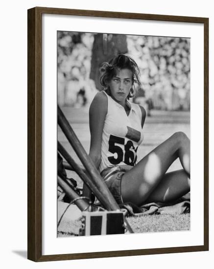 Gunhild Larking, Sweden's Entry for High Jump, Nervously Awaiting Turn to Compete at Olympic Games-George Silk-Framed Premium Photographic Print