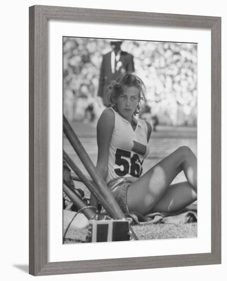 Gunhild Larking, Sweden's Entry for High Jump, Nervously Awaiting Turn to Compete at Olympic Games-George Silk-Framed Premium Photographic Print