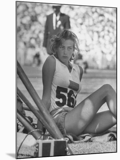 Gunhild Larking, Sweden's Entry for High Jump, Nervously Awaiting Turn to Compete at Olympic Games-George Silk-Mounted Premium Photographic Print