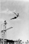 1930s 1940s SHAPELY WOMAN WATCHING MAN SWAN DIVE OFF HIGH DIVING BOARD-H. Armstrong Roberts-Photographic Print