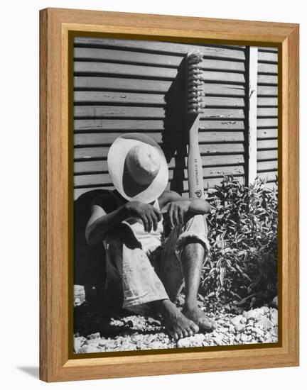 Haitian Native Engaged in a Siesta Next to Giant American Toothbrush Ad He Totes Around the Streets-Rex Hardy Jr.-Framed Premier Image Canvas