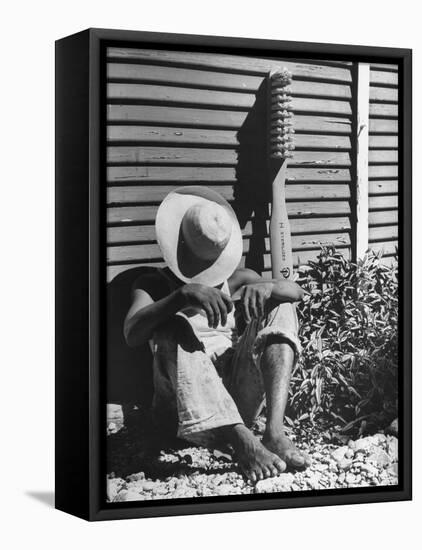 Haitian Native Engaged in a Siesta Next to Giant American Toothbrush Ad He Totes Around the Streets-Rex Hardy Jr.-Framed Premier Image Canvas