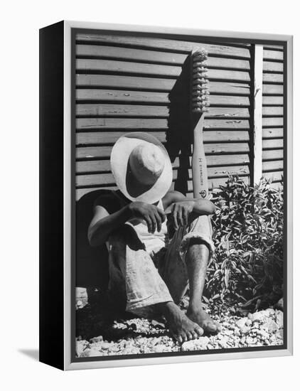 Haitian Native Engaged in a Siesta Next to Giant American Toothbrush Ad He Totes Around the Streets-Rex Hardy Jr.-Framed Premier Image Canvas