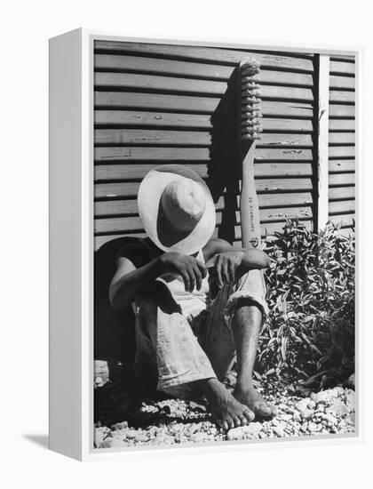 Haitian Native Engaged in a Siesta Next to Giant American Toothbrush Ad He Totes Around the Streets-Rex Hardy Jr.-Framed Premier Image Canvas