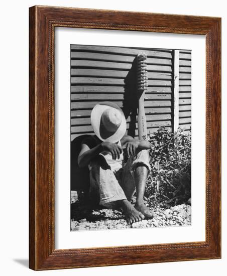 Haitian Native Engaged in a Siesta Next to Giant American Toothbrush Ad He Totes Around the Streets-Rex Hardy Jr.-Framed Photographic Print