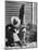 Haitian Native Engaged in a Siesta Next to Giant American Toothbrush Ad He Totes Around the Streets-Rex Hardy Jr.-Mounted Photographic Print