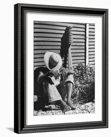 Haitian Native Engaged in a Siesta Next to Giant American Toothbrush Ad He Totes Around the Streets-Rex Hardy Jr.-Framed Photographic Print