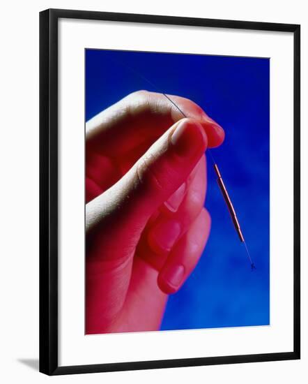 Hand Holds a GyneFIX Intrauterine Contraceptive-Damien Lovegrove-Framed Photographic Print