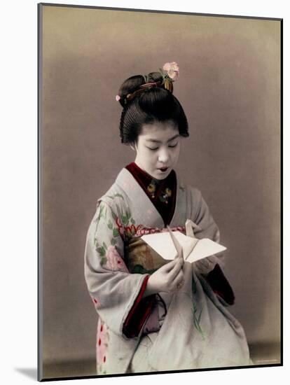 Hand Tinted Photograph of Japanese Dancing Girl Making Paper Bird-null-Mounted Photographic Print