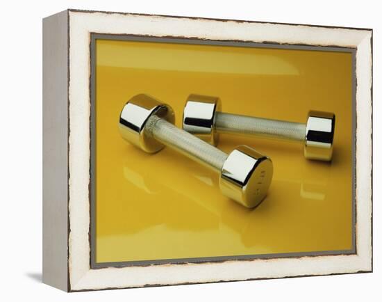 Hand Weights on a Reflective Yellow Surface-null-Framed Premier Image Canvas